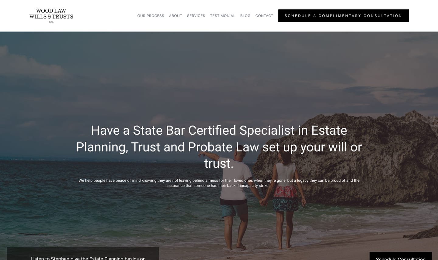 The old Wood Law homepage on a laptop: a 19-word headline over a beach photo and a consultation button